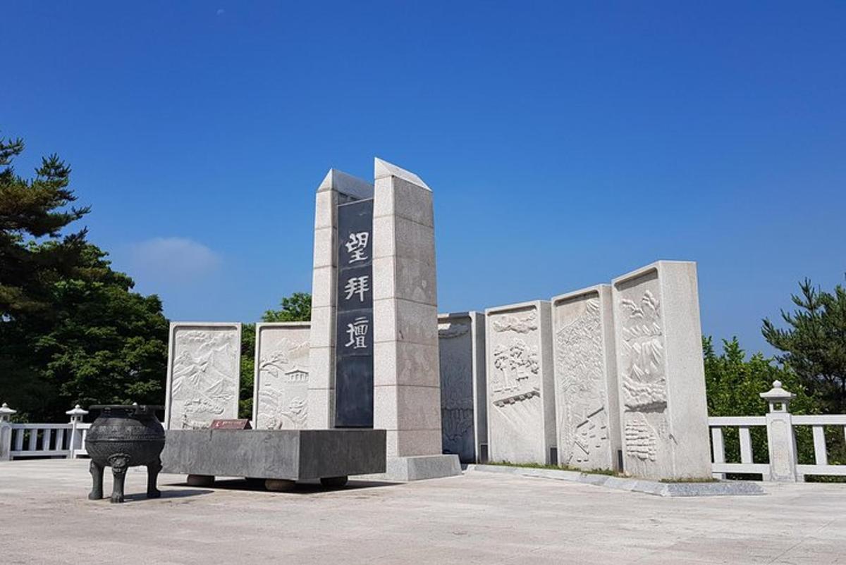 a monument with a statue in front of a building