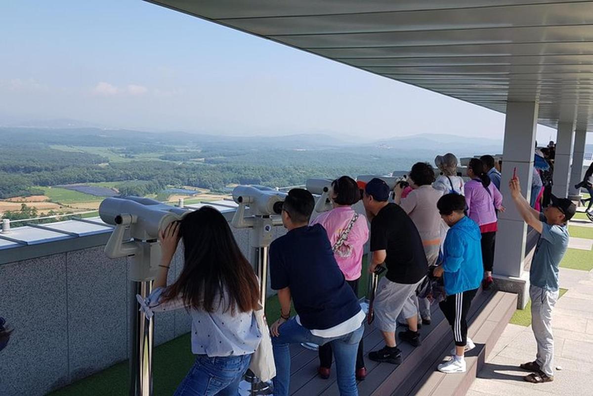 a group of people standing on top of a building