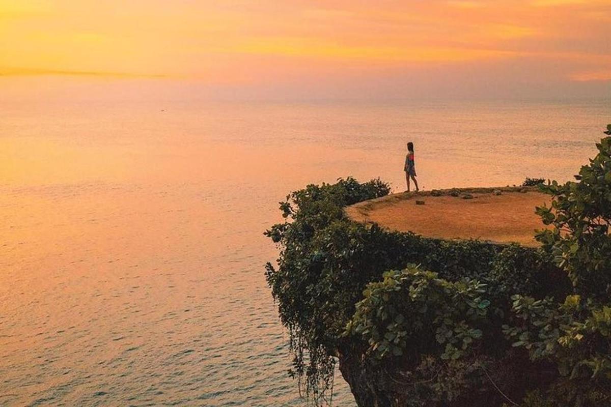 osoba stojící na ostrově v oceánu
