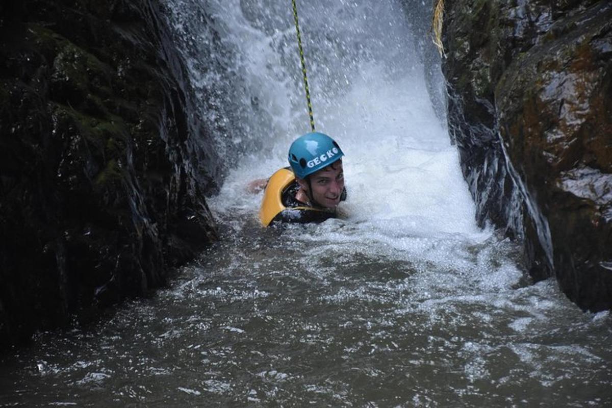 a man in a raft in a waterfall
