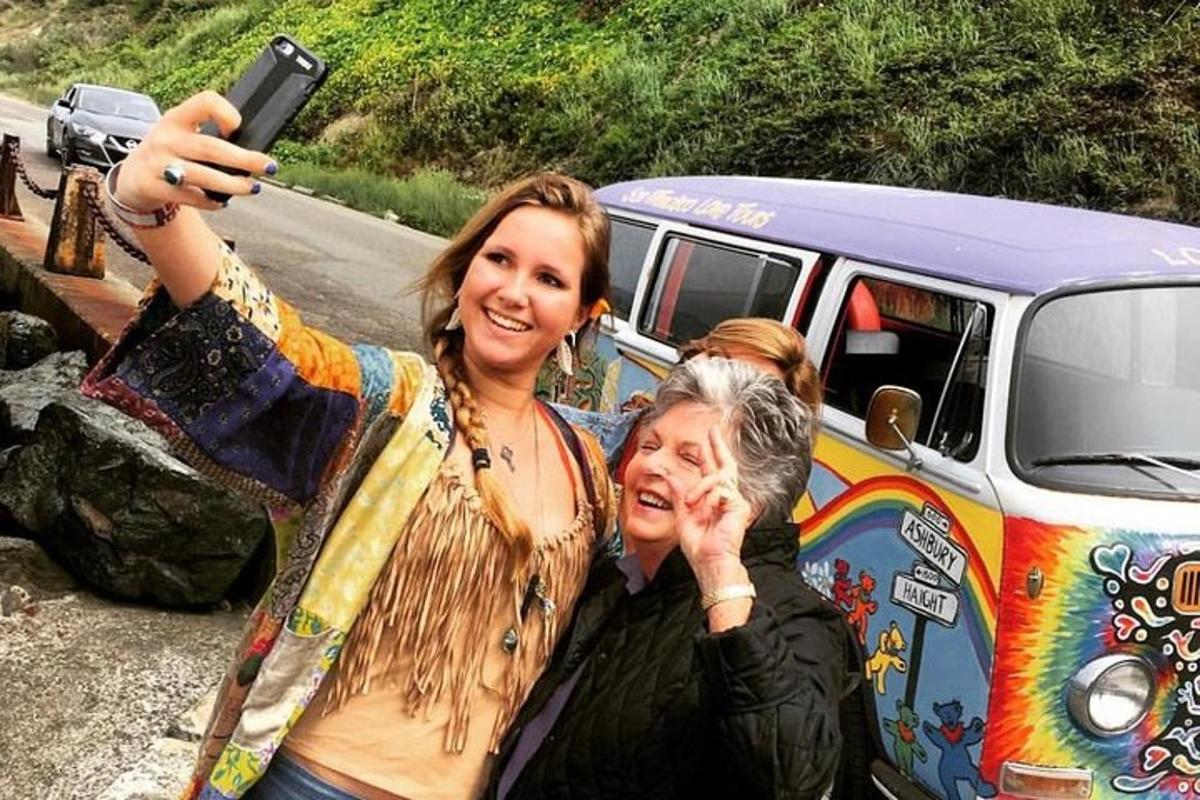 two women are taking a picture of a van