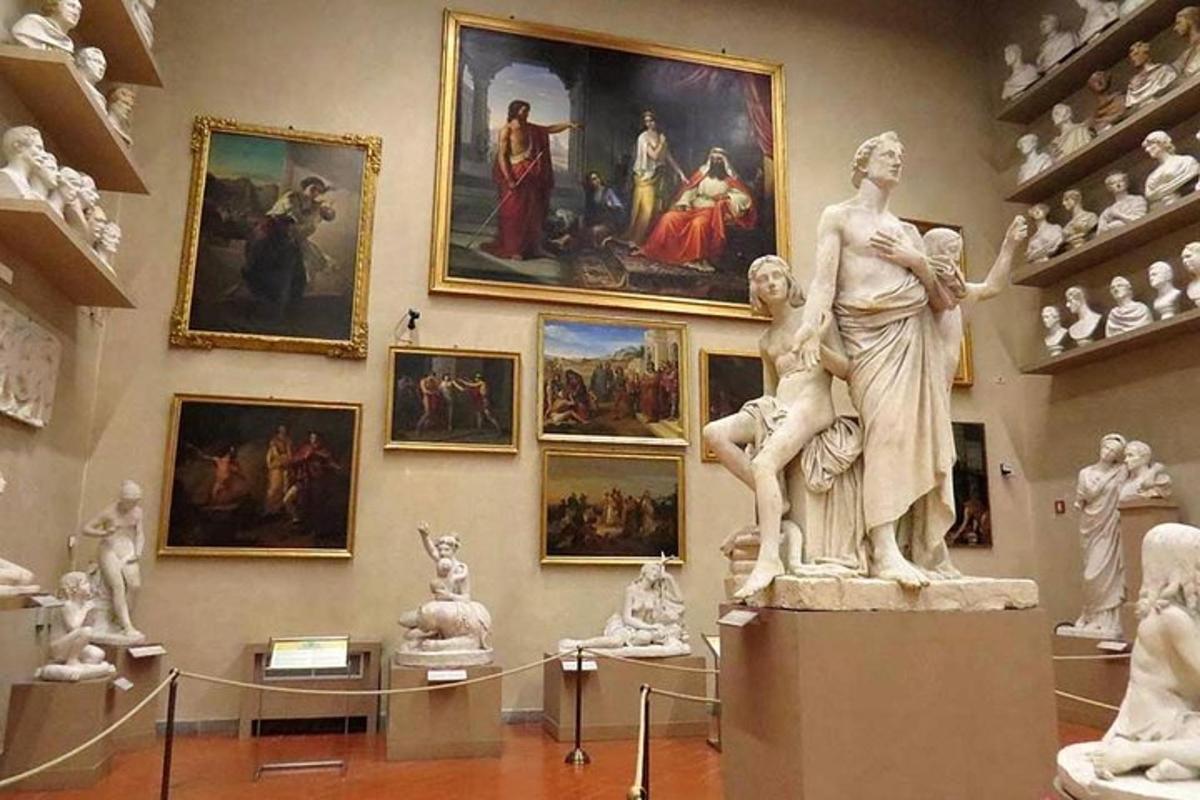 a museum with statues and paintings on a wall