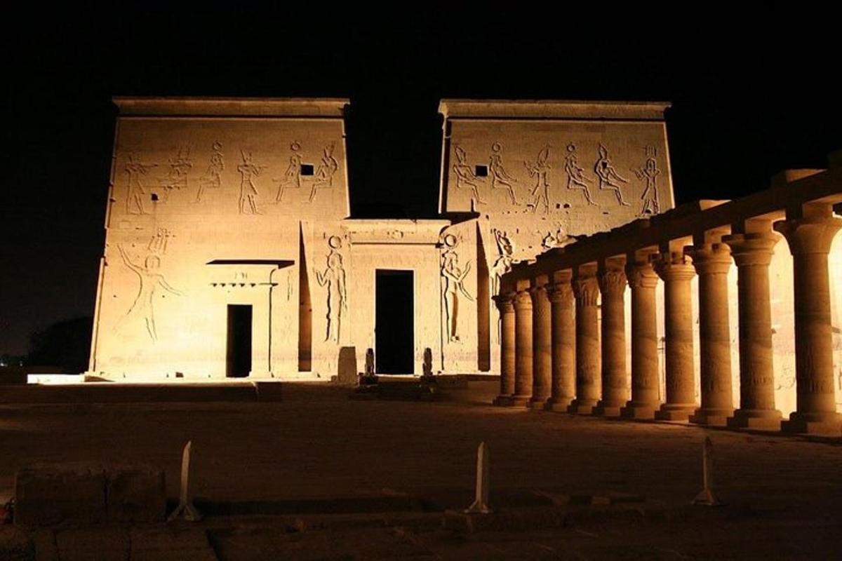 a building with graffiti on the side of it at night