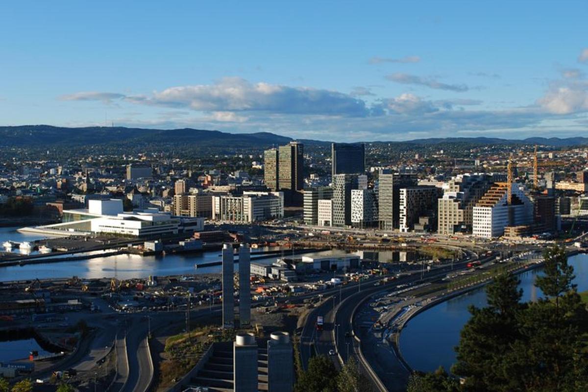 a city with a bridge and a river and buildings