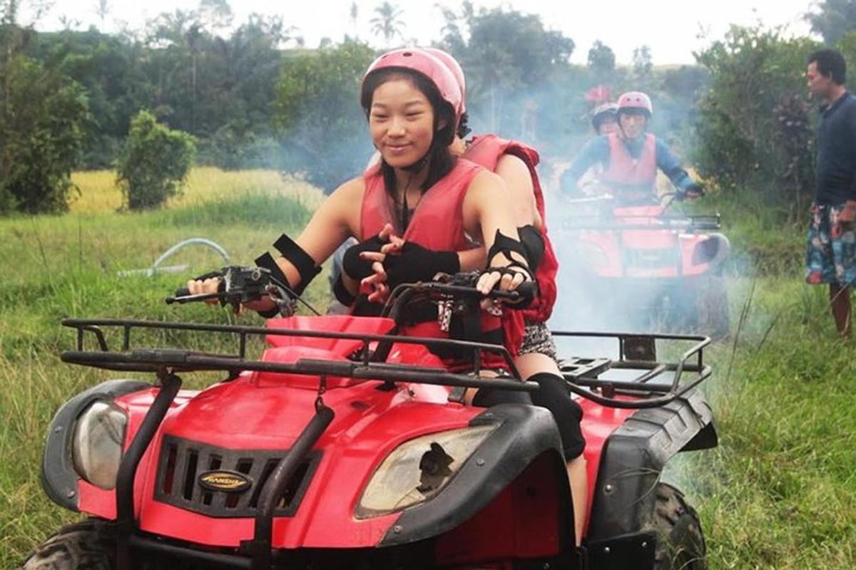 a woman is riding on a four wheeler