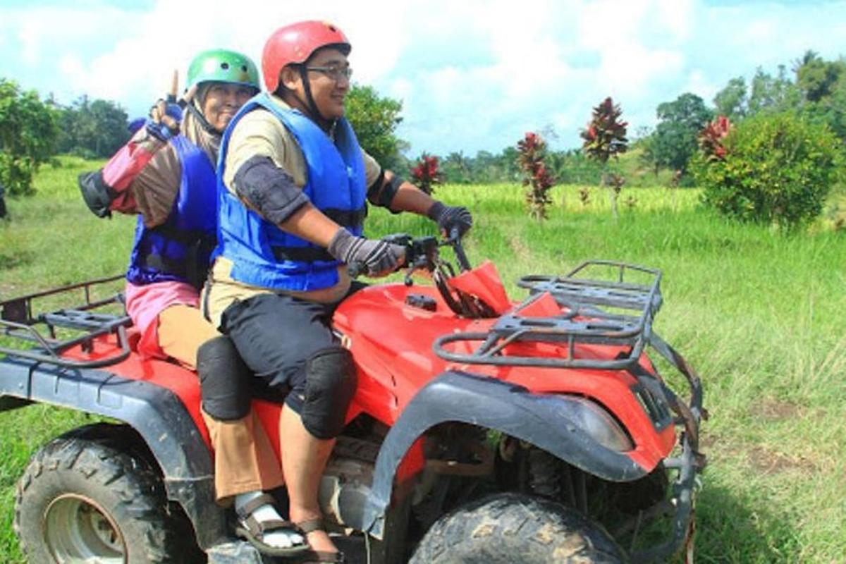 a man and a woman riding on a four wheeler