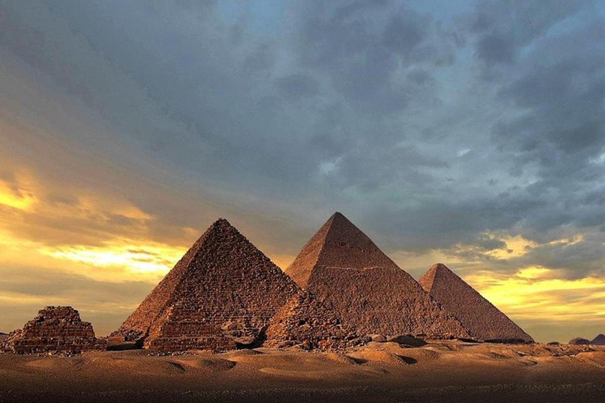 un gruppo di piramidi nel deserto al tramonto