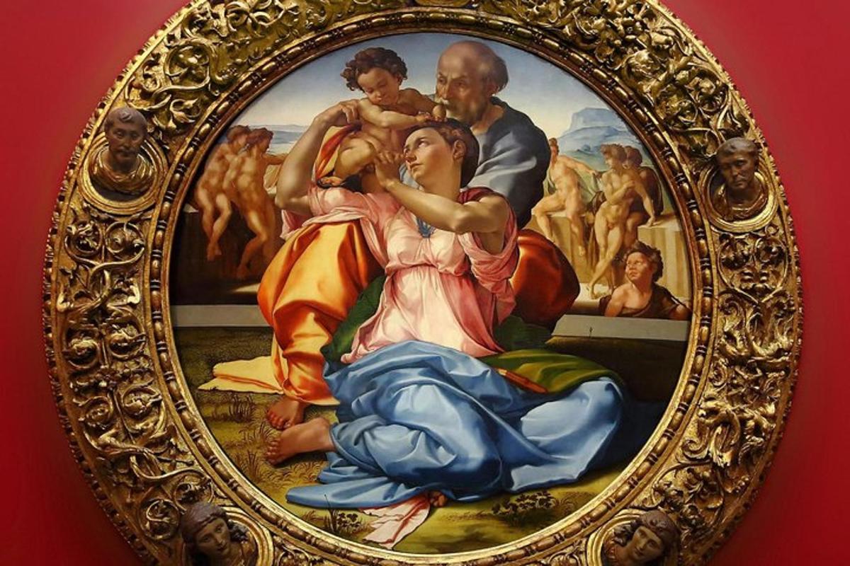 a painting in a gold frame on a wall