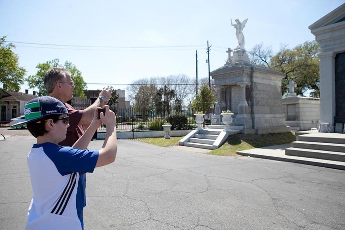 a man taking a picture of a boy taking a picture of a statue