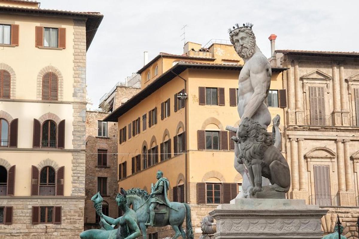 a statue in the middle of a city with buildings