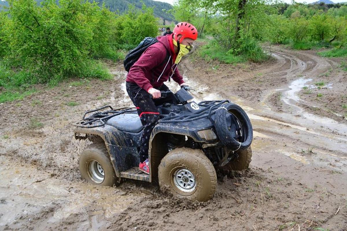 a person riding a four wheeler on a dirt road