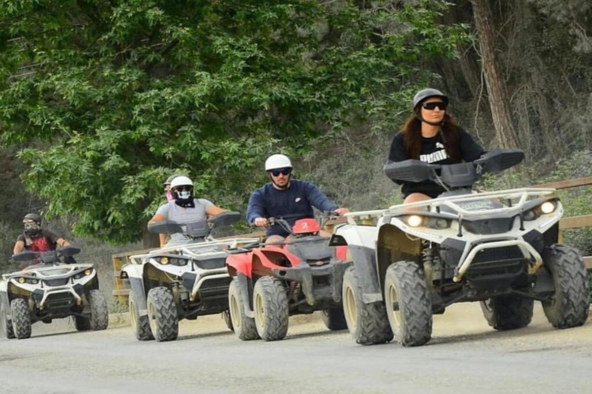 a group of people riding atvs down a road