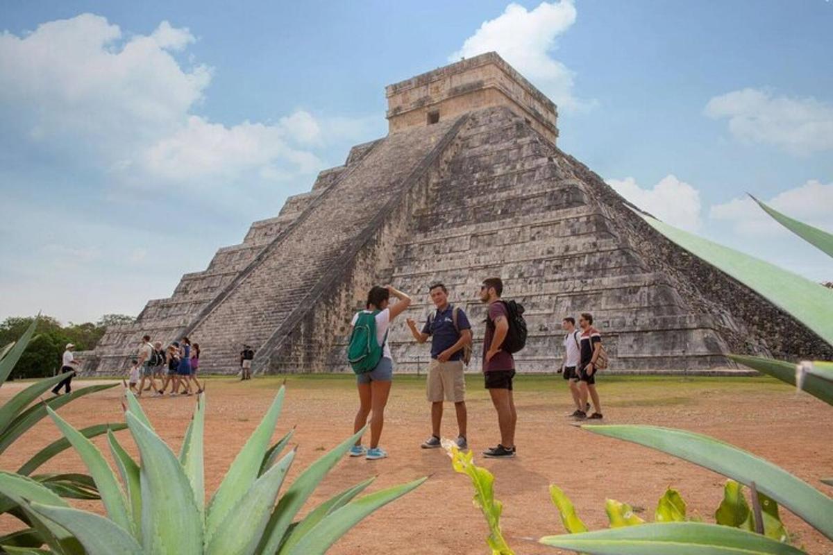 a group of people standing in front of the pyramid