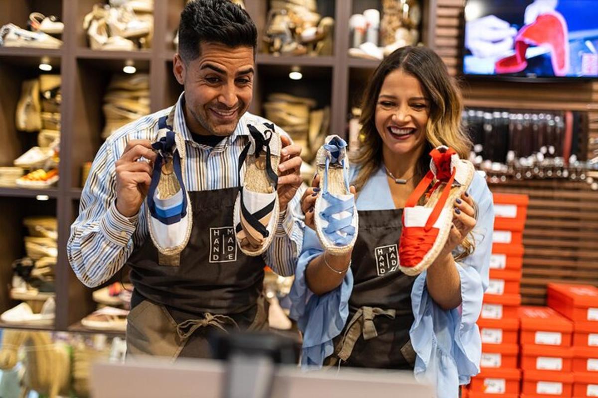 a man and a woman holding up pairs of shoes