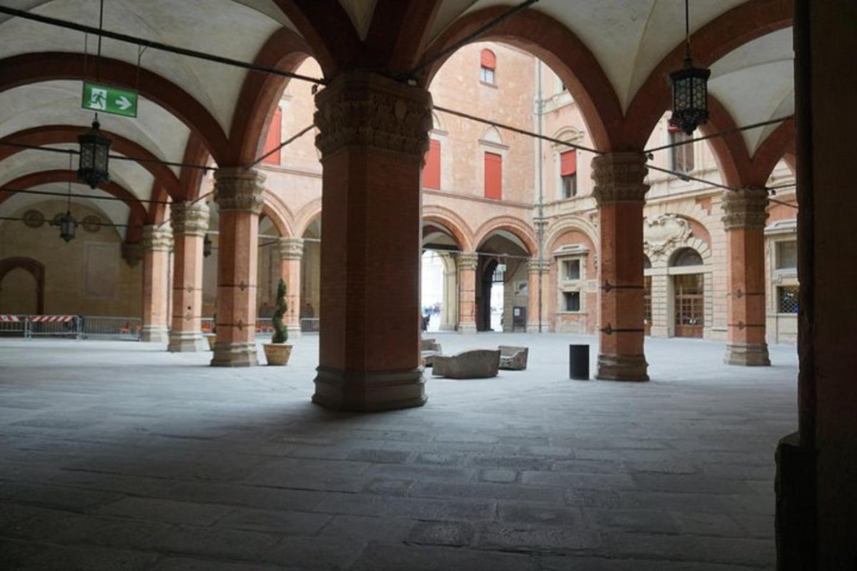 an empty room with columns and arches in a building