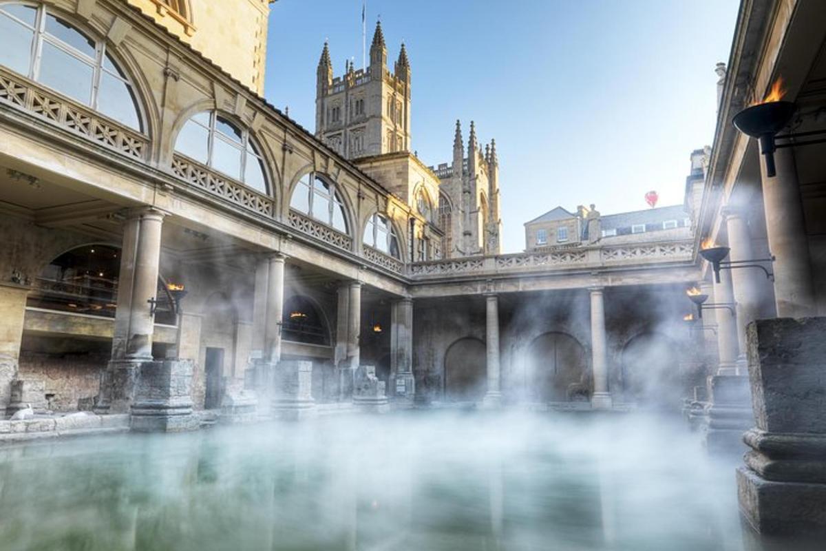 a building with a pool of water with a clock tower