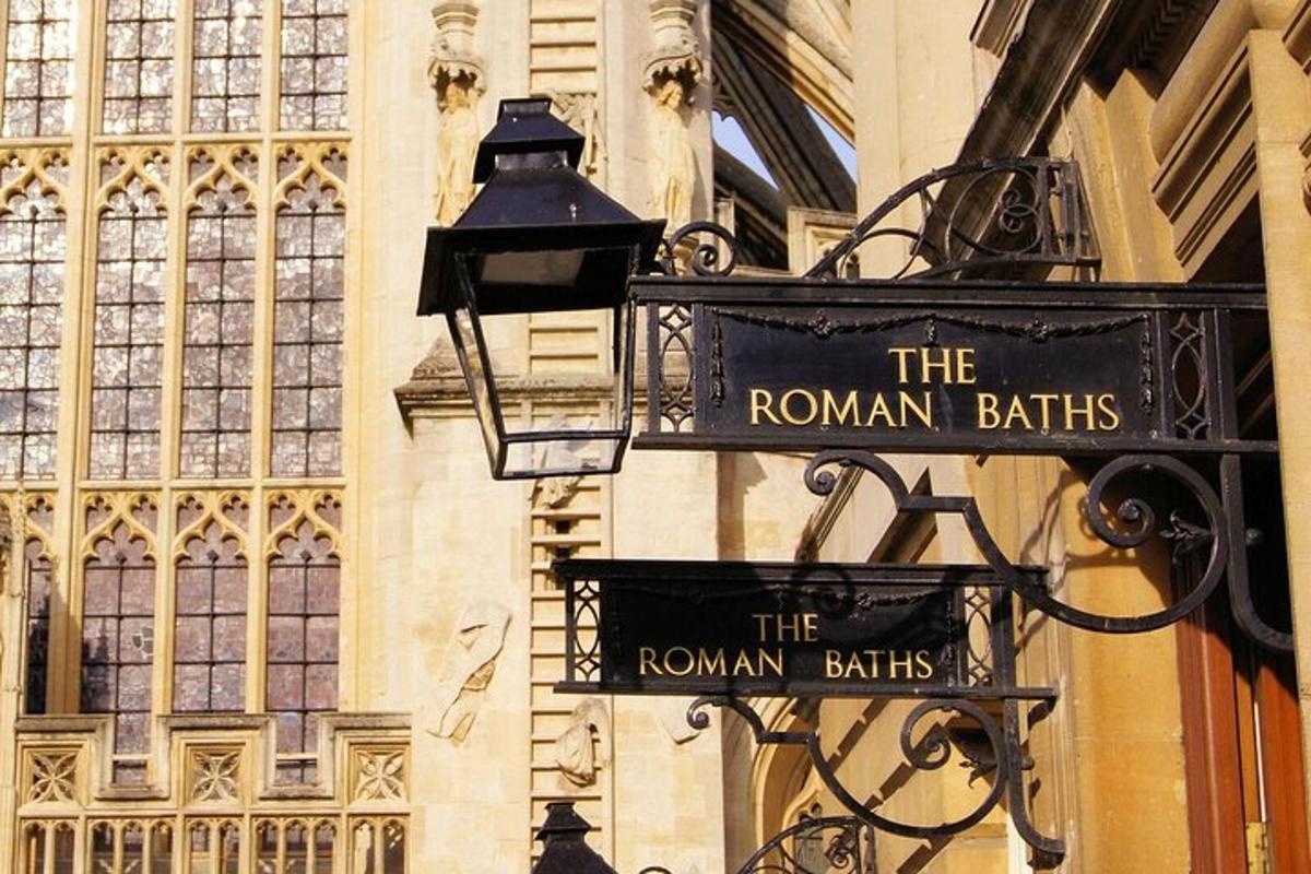 a sign for the roman baths on the side of a building