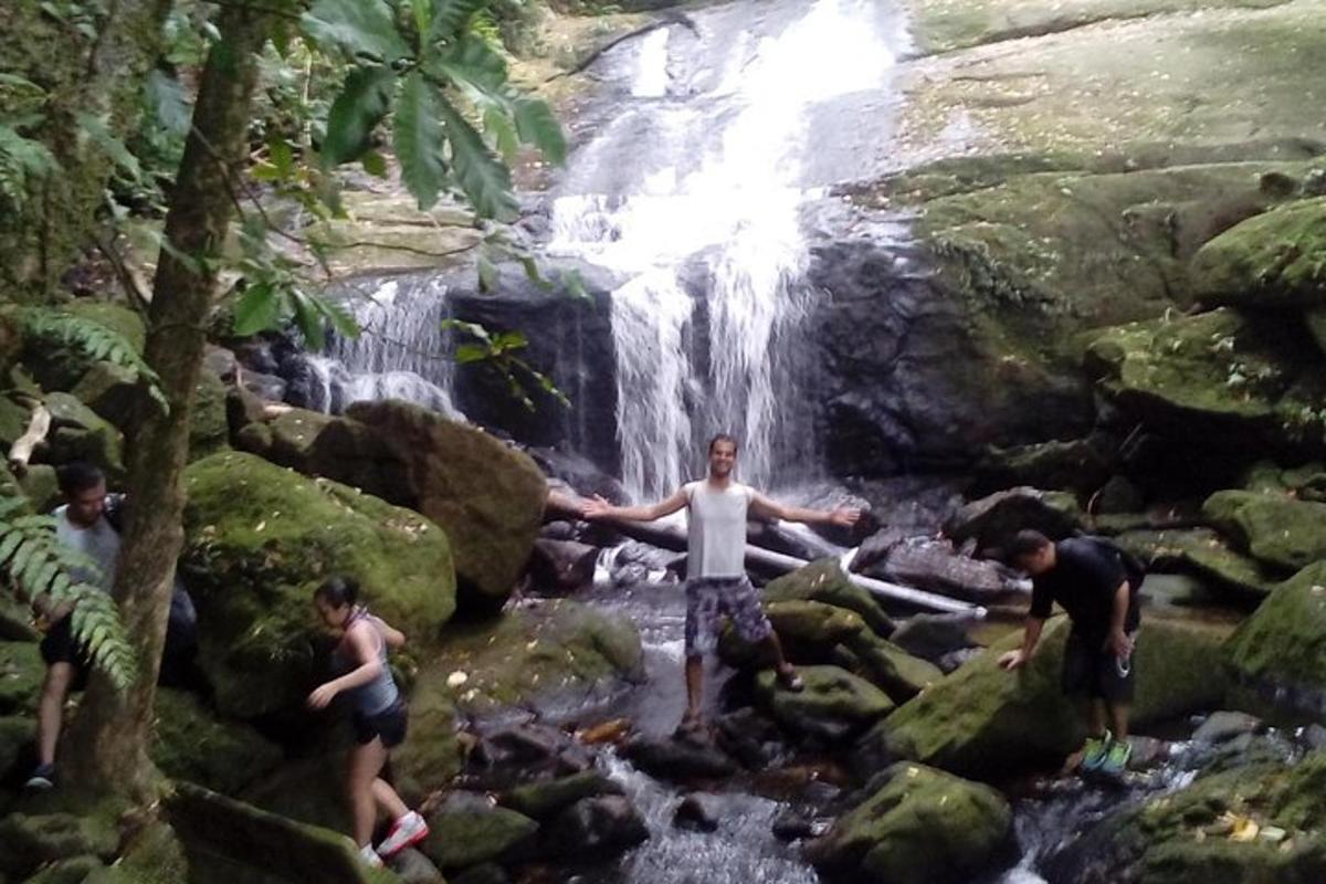 a group of people standing in front of a waterfall