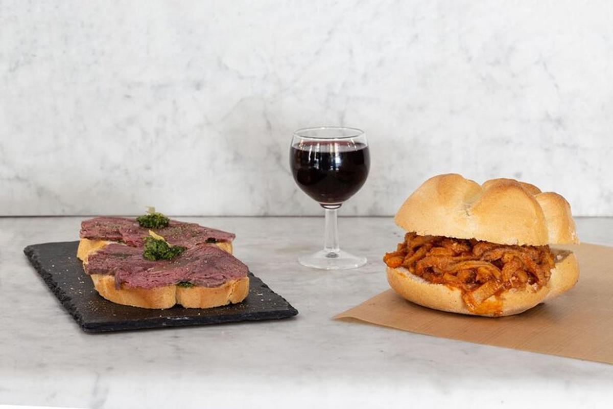 a sandwich and a glass of wine on a table