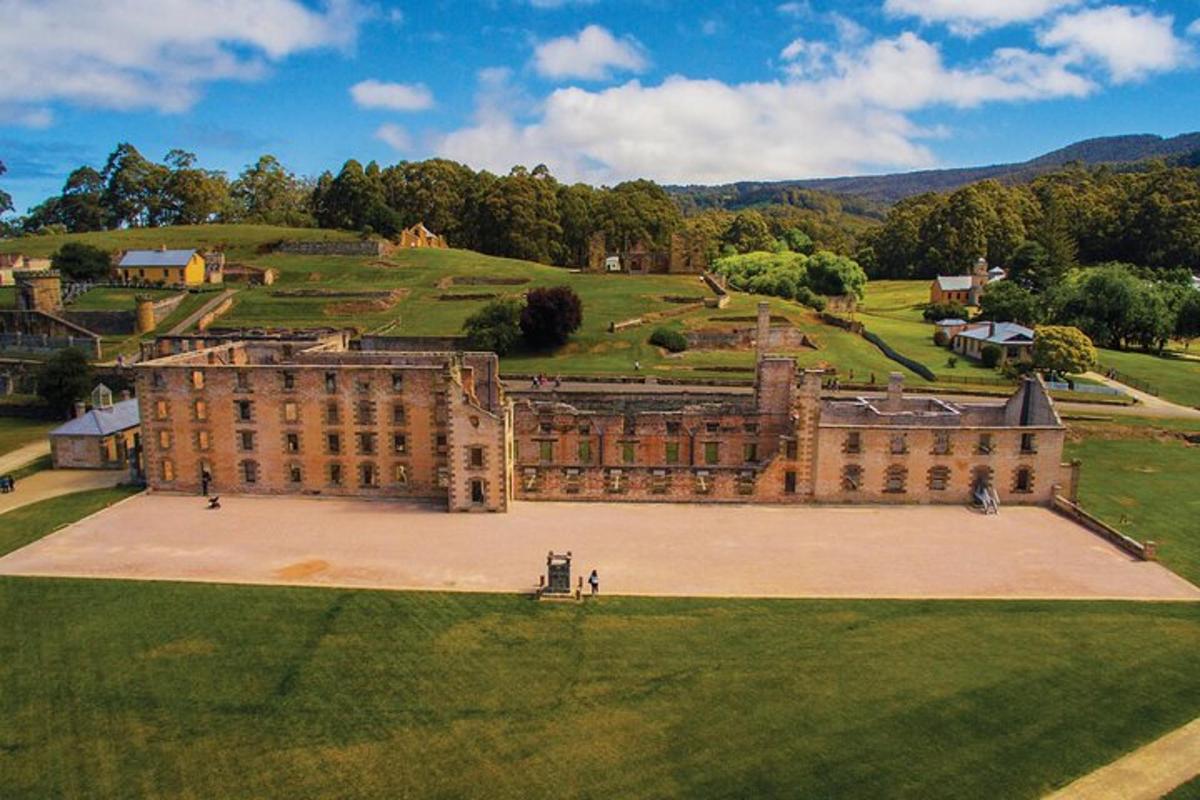 an aerial view of a large building with a large yard