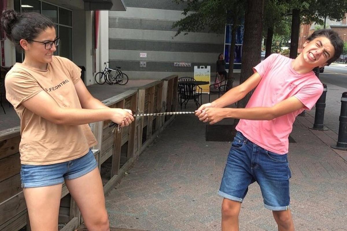 two people are playing with a rope