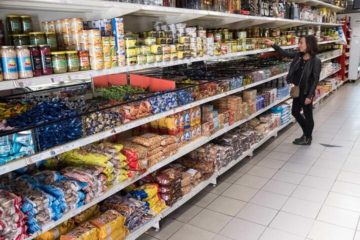 a woman is standing in a supermarket aisle