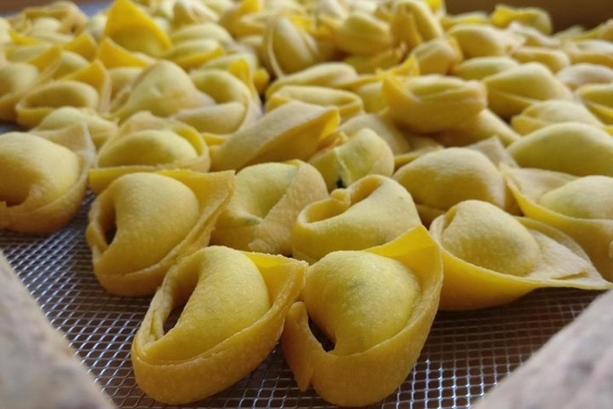a pile of yellow pasta on a metal grate
