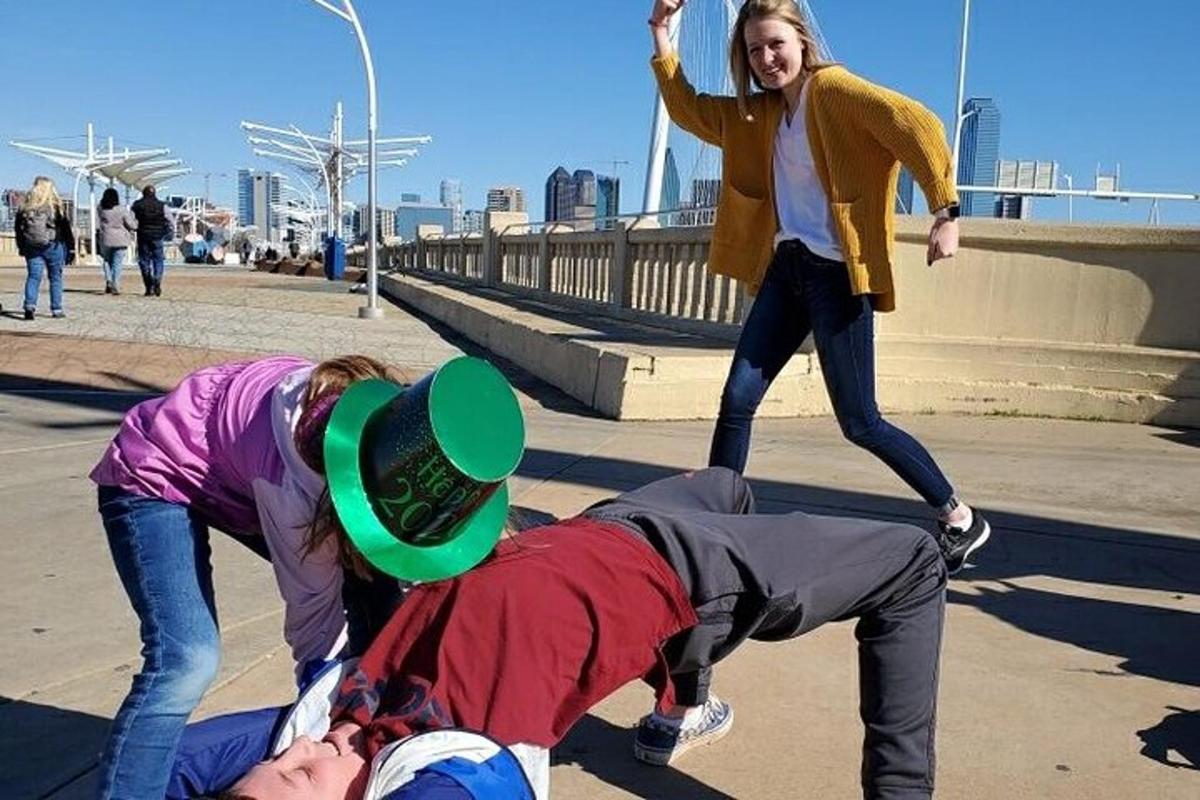 a group of people dancing on a sidewalk