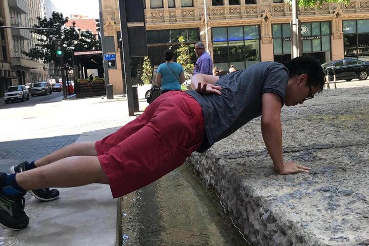 a young boy is laying on a wall