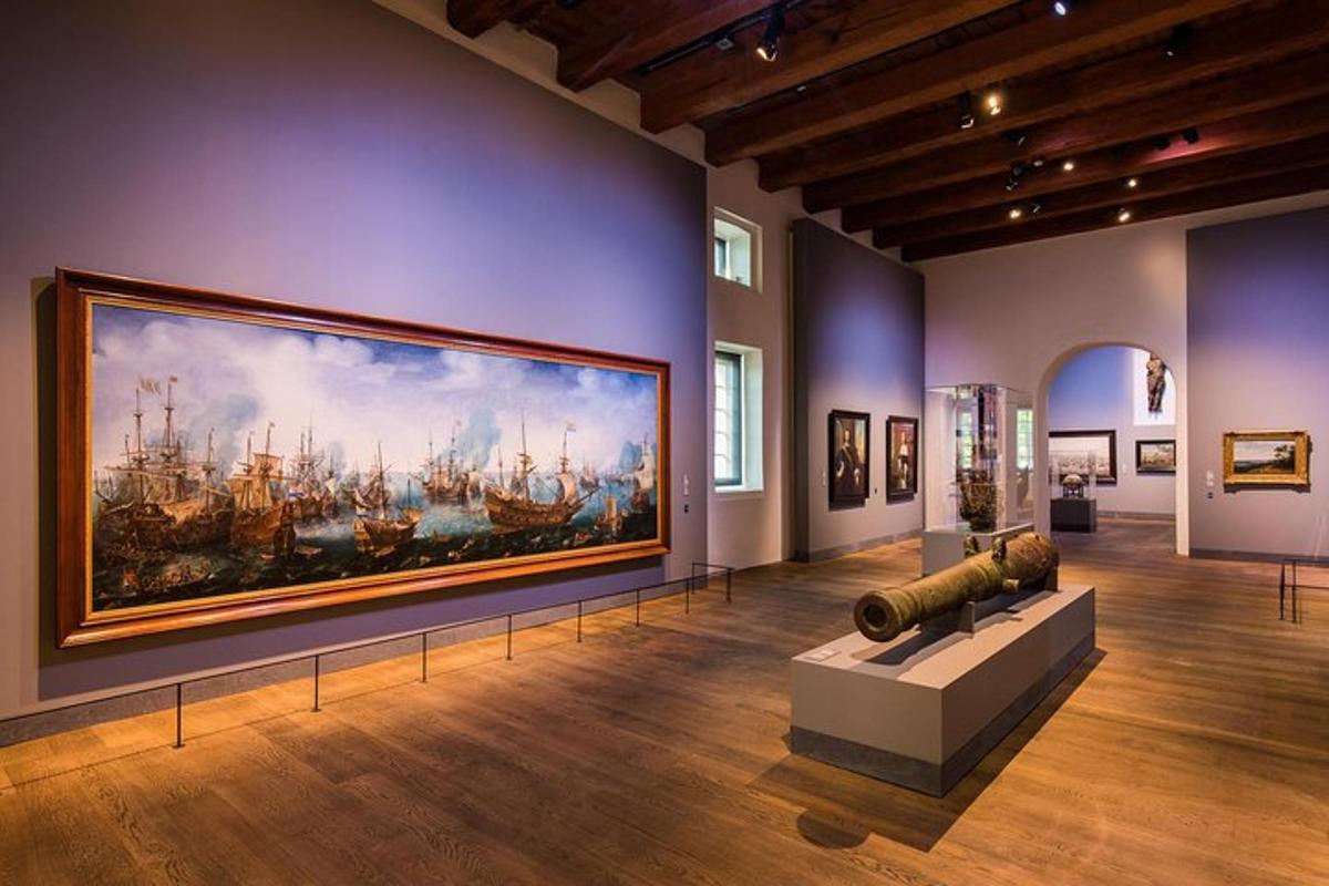 a museum with a large painting of ships on the wall