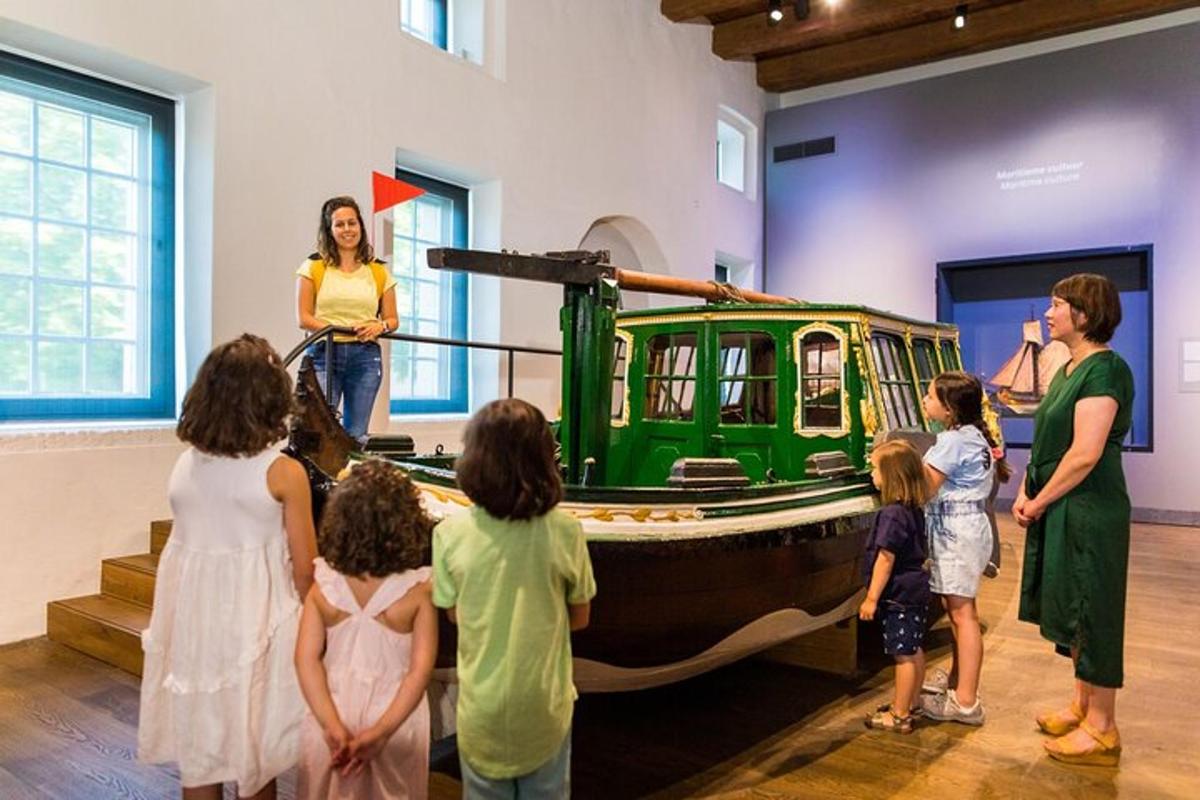 a group of children looking at a boat in a museum