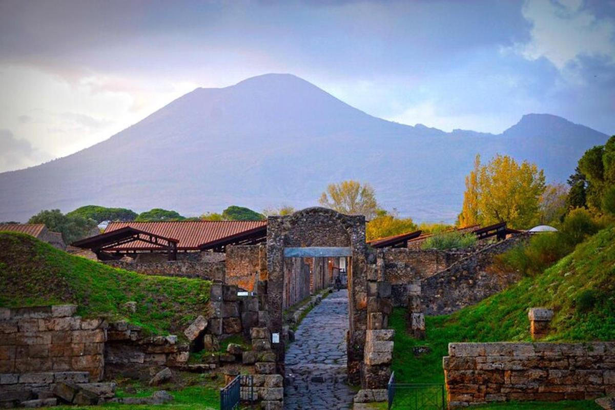 a stone building with a mountain in the background
