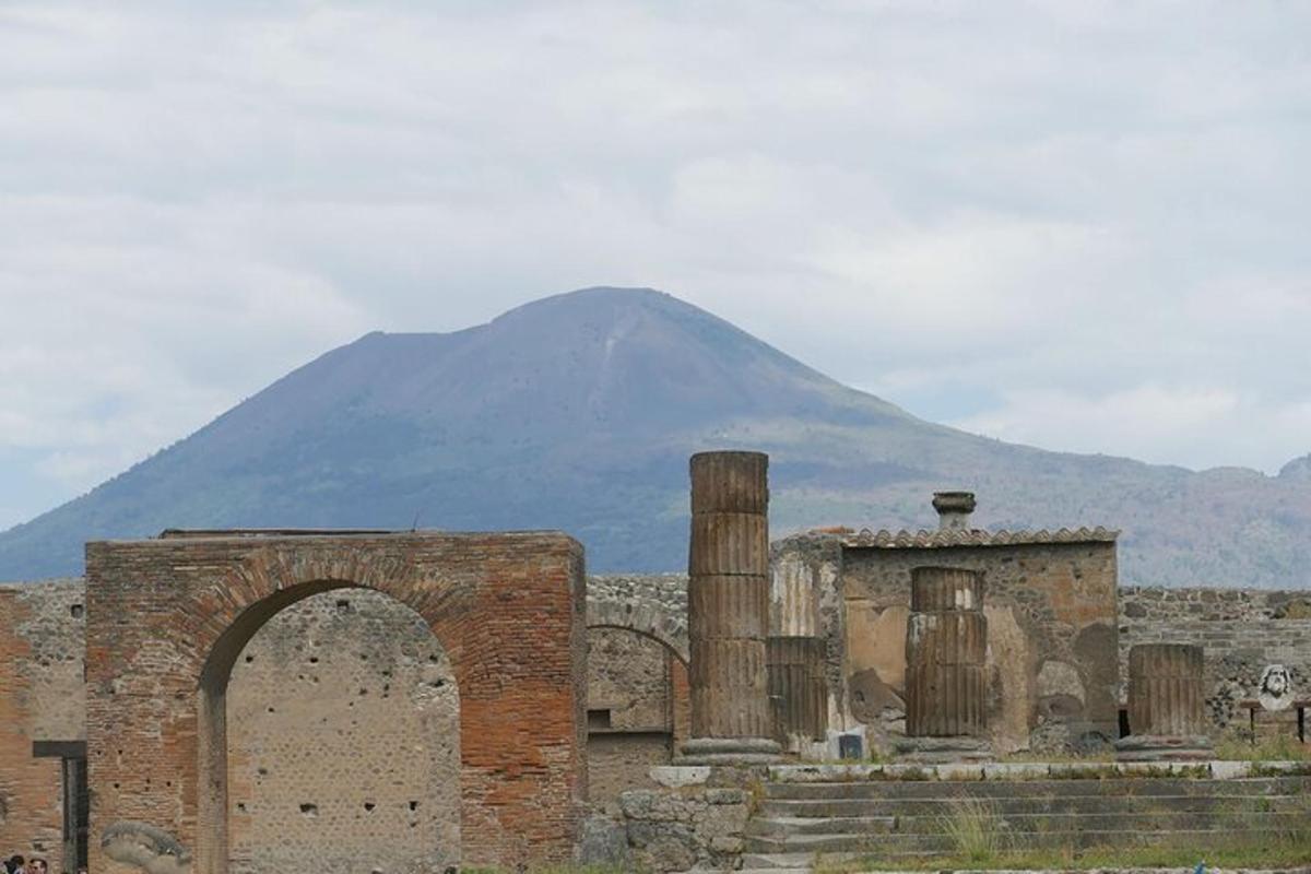 an ancient building with a mountain in the background