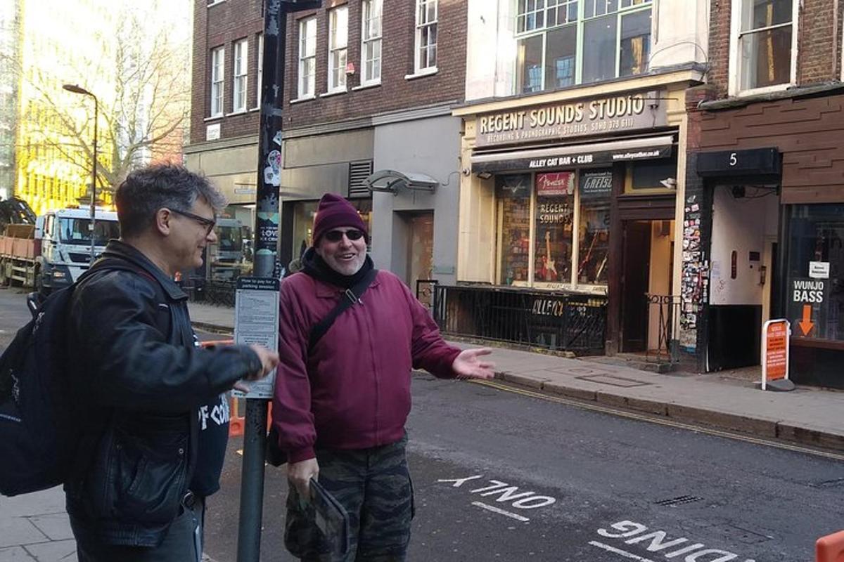 two men are standing on a city street