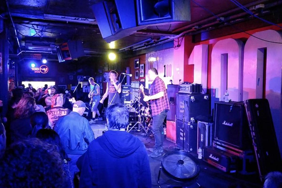 a group of people in a room with a band on a stage