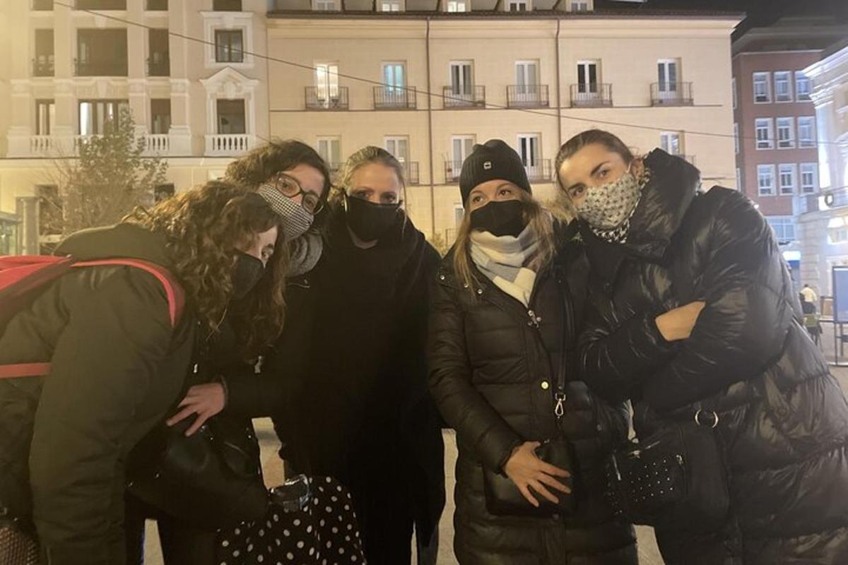 a group of people wearing face masks in front of a building