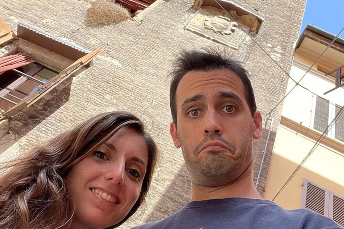 a man and a woman standing in front of a building
