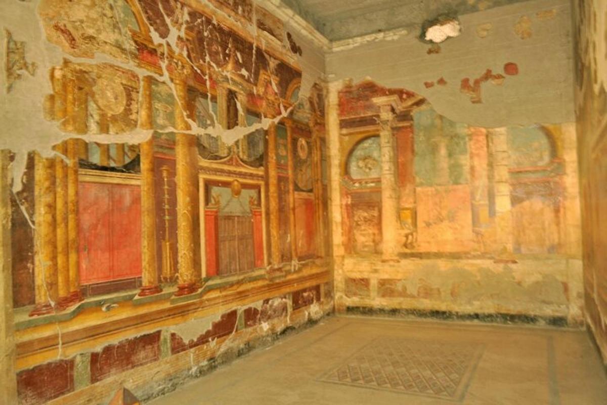 an old room with a painting on the wall