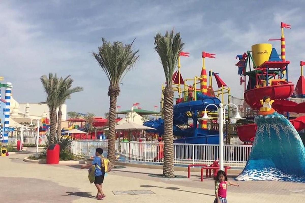 a water park with a water slide and palm trees