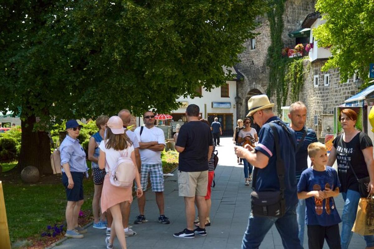 μια ομάδα ανθρώπων που στέκονται σε ένα πεζοδρόμιο