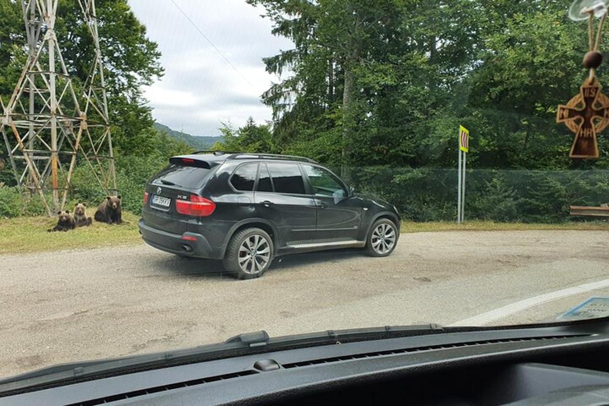 a black car parked on the side of a road