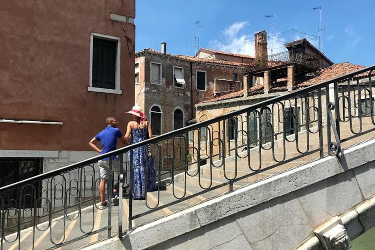 two people standing on a balcony looking out over buildings