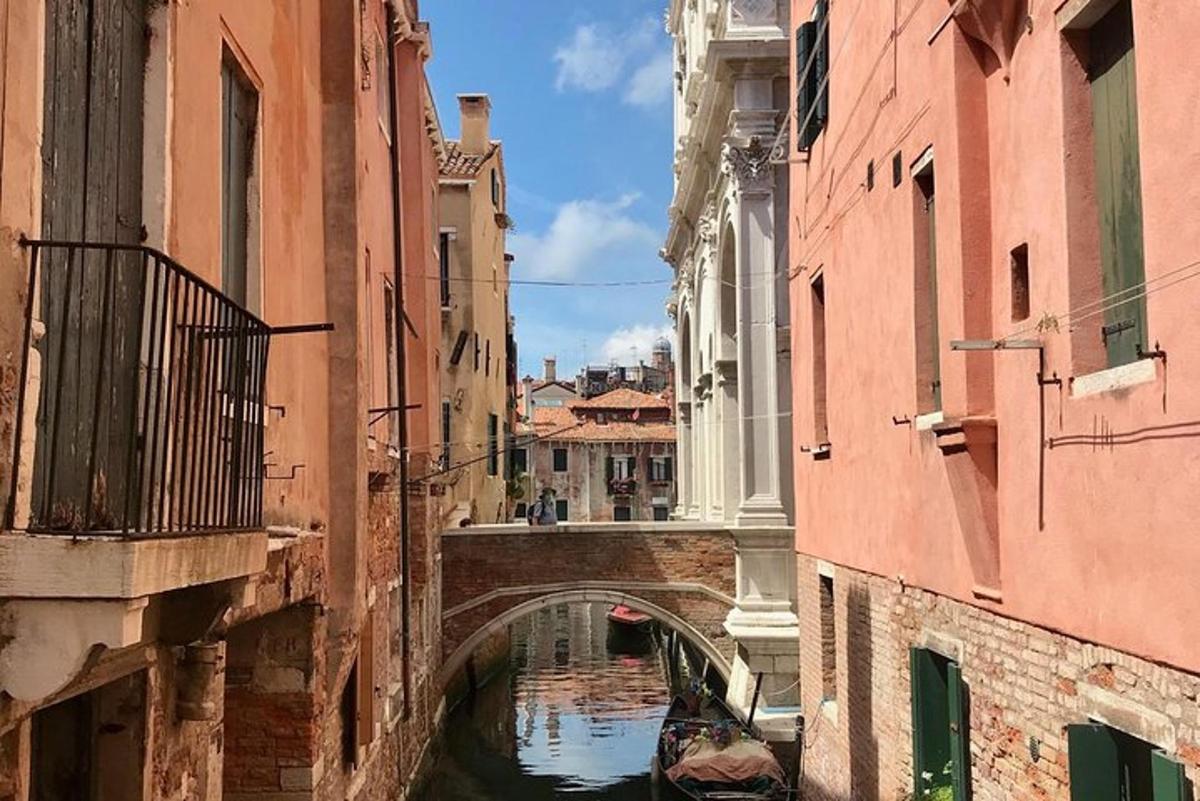a canal with a bridge and a boat in the water