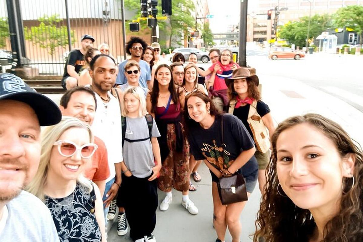 a group of people posing for a picture on a street