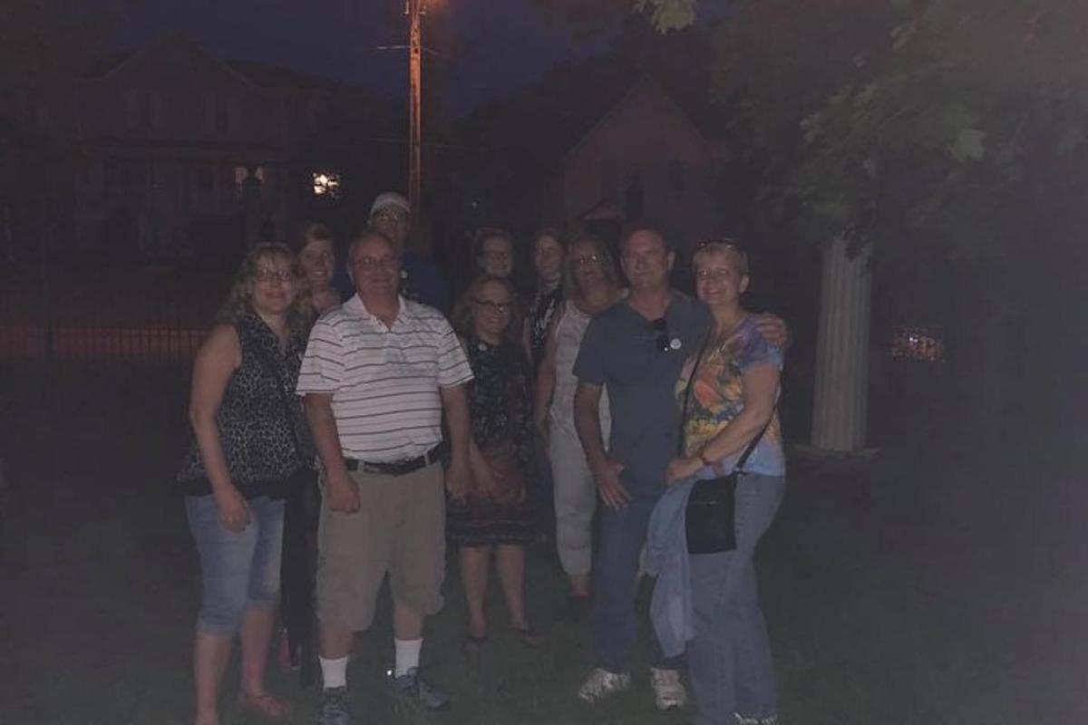 a group of people posing for a picture at night