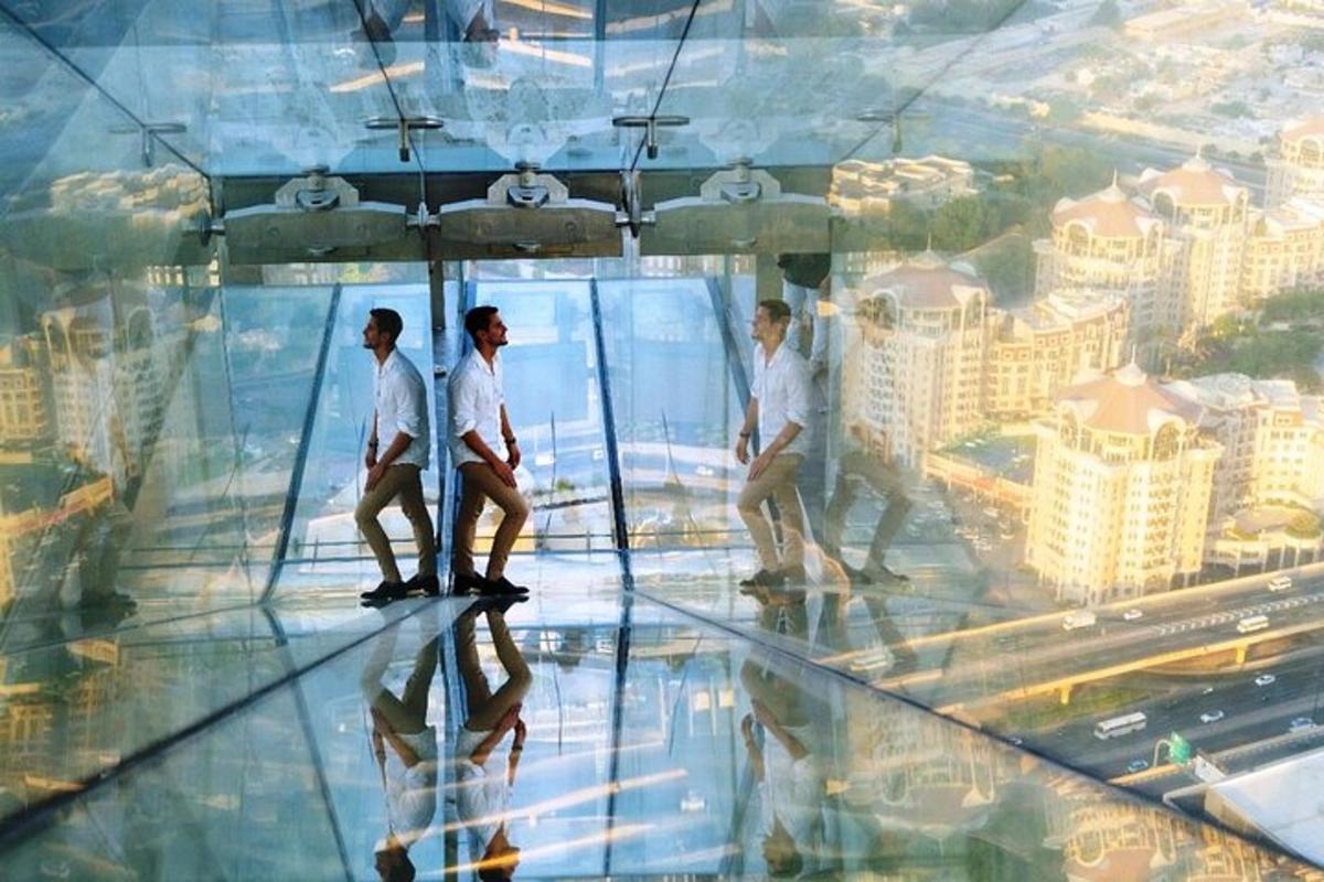 a group of men walking on the glass floor of a building