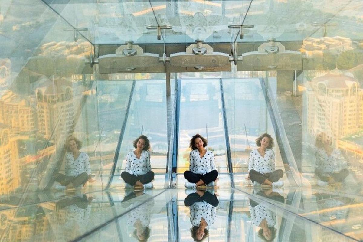 a group of women sitting on a glass floor