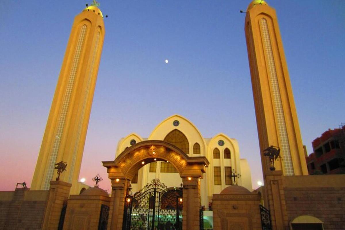 a large building with two towers with a gate