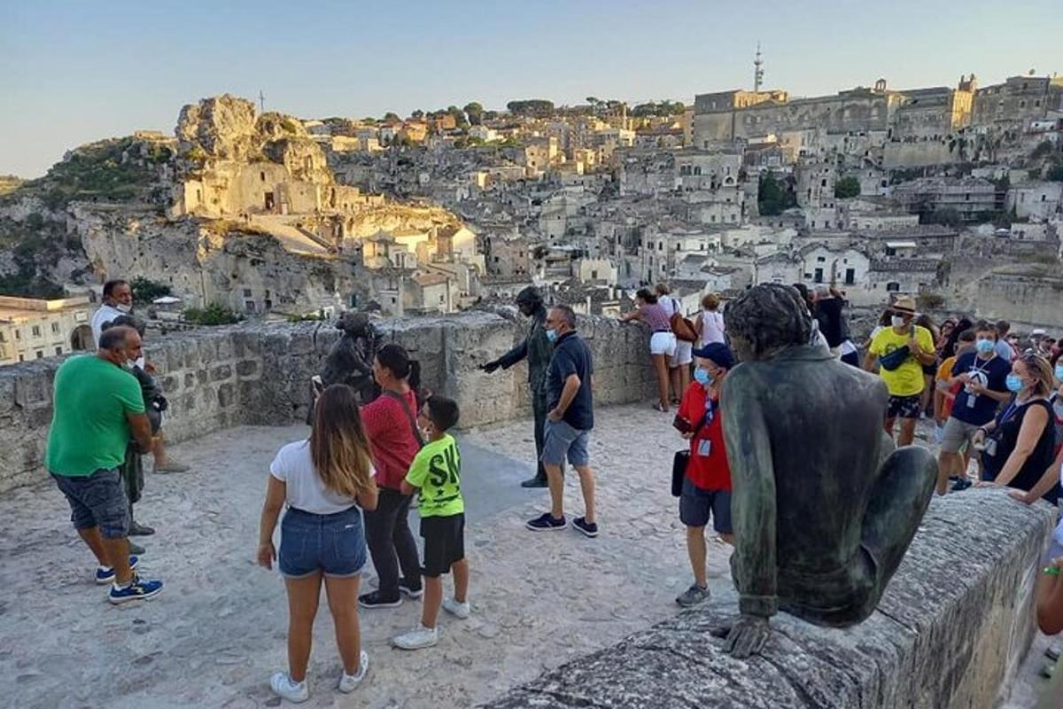 a group of people standing around a statue
