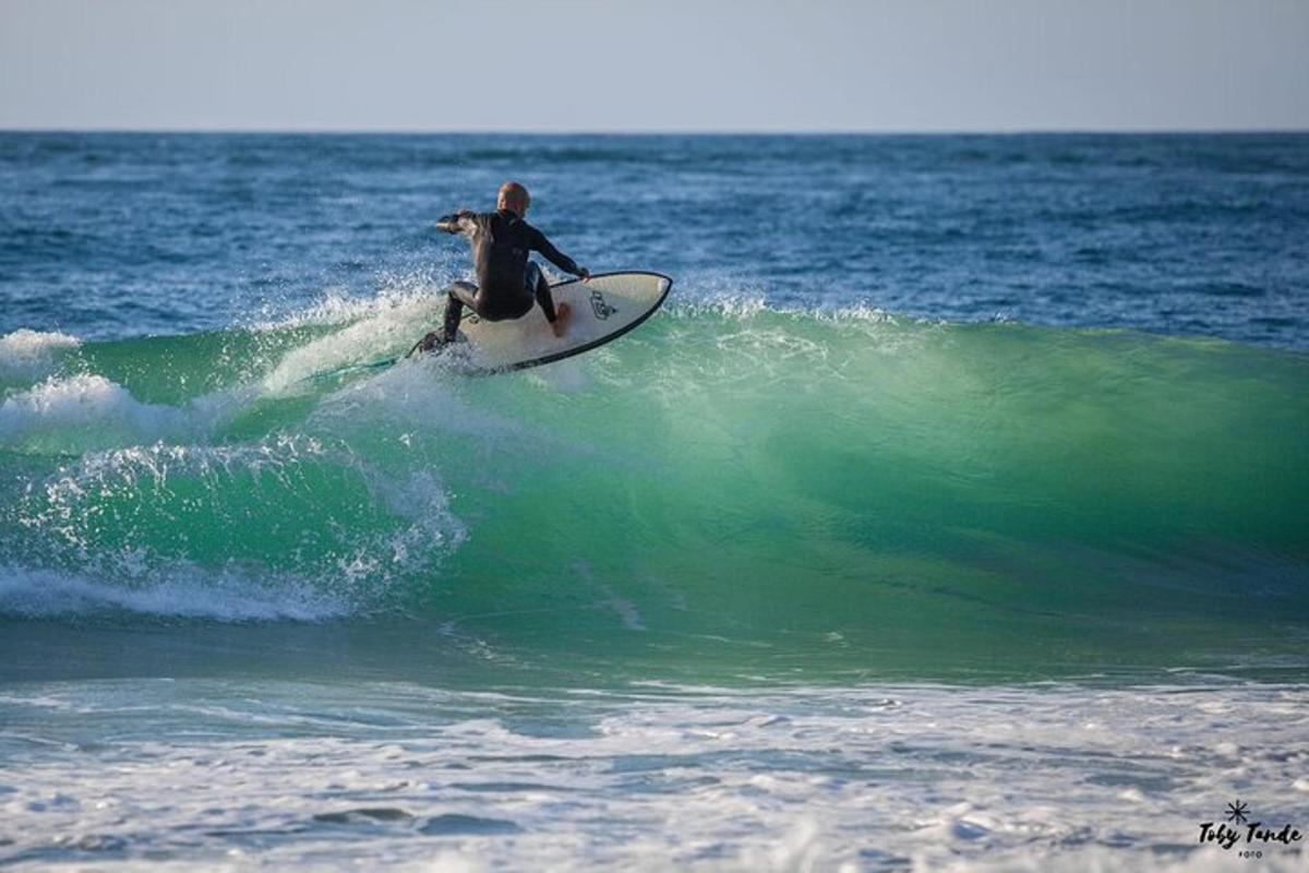 a man riding a wave on a surfboard in the ocean